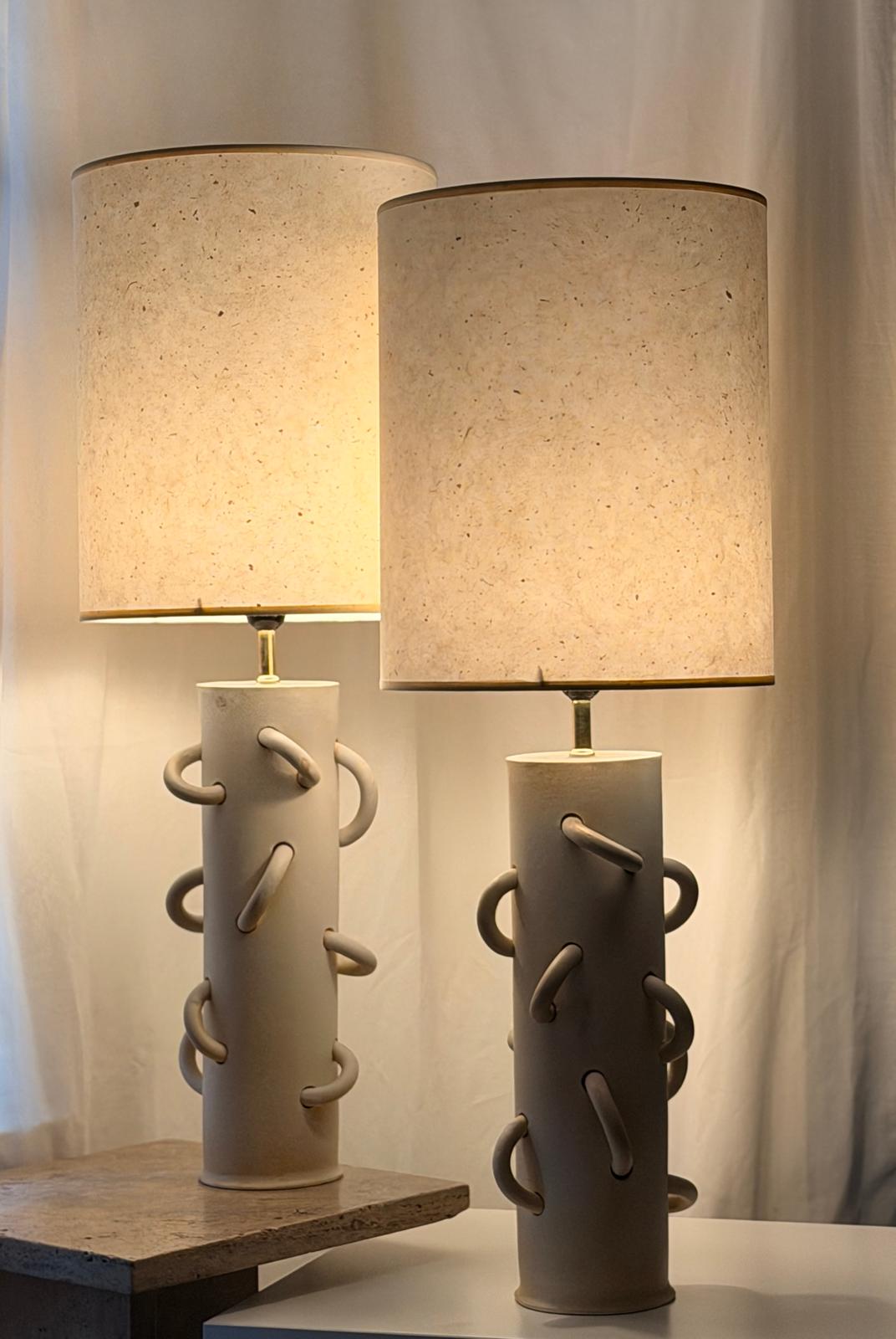 Lightly glazed, white loop lamp with off-white kozo paper shade.