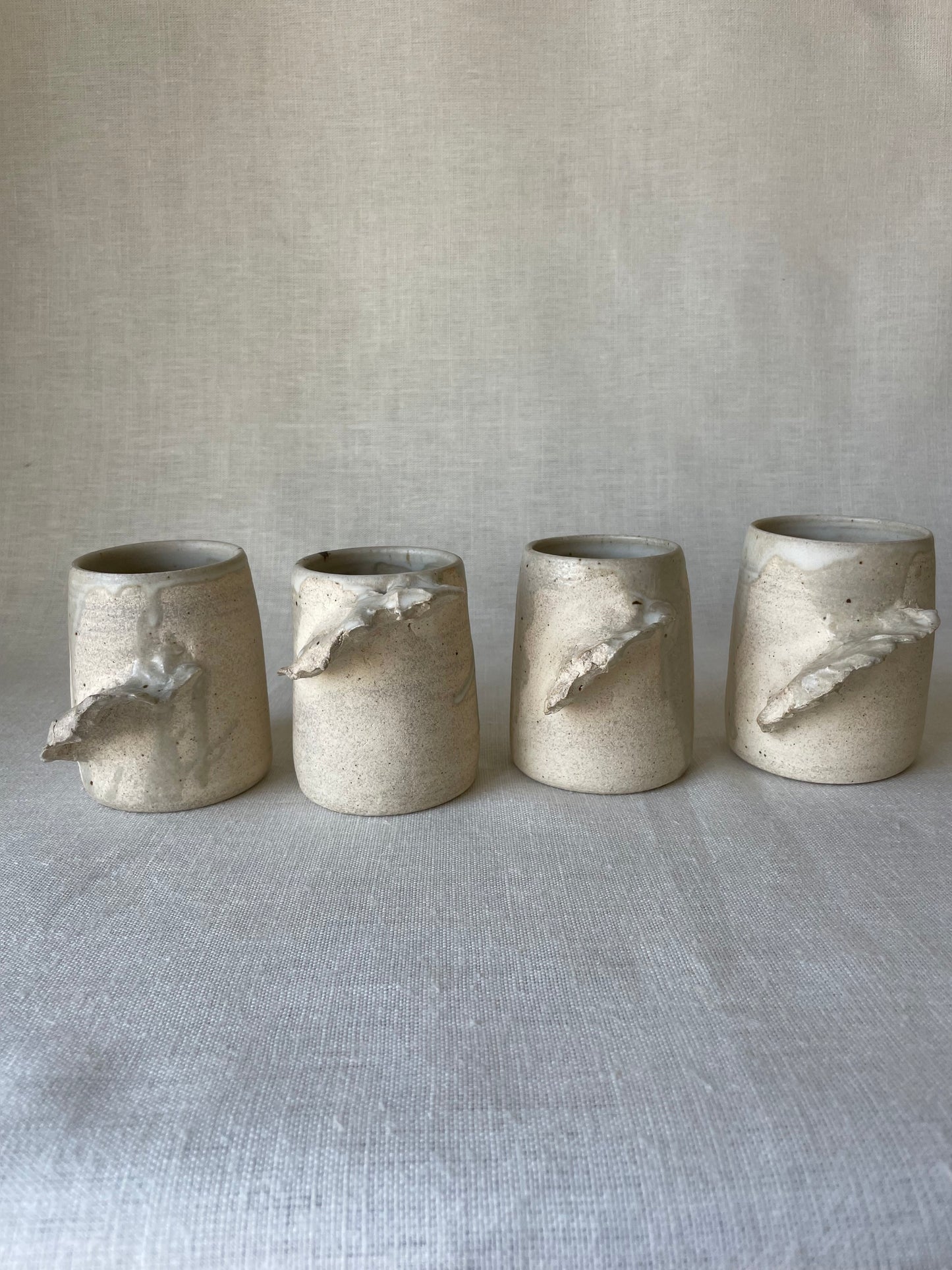 Winged Stone Ceramic Mugs